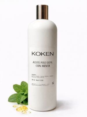 Aceite post depilatorio Koken con menta 500ml en botella blanca con tapón plateado sobre fondo blanco con hojas de menta fresca