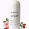 Aceite post depilatorio rosa mosqueta Koken 1 litro en botella blanca grande sobre fondo blanco con flor de rosa y frutos de rosa mosqueta — formato profesional para centros de estética