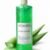 Gel predepilatorio aloe vera Koken 500ml en botella verde con dosificador sobre fondo blanco con planta de aloe vera